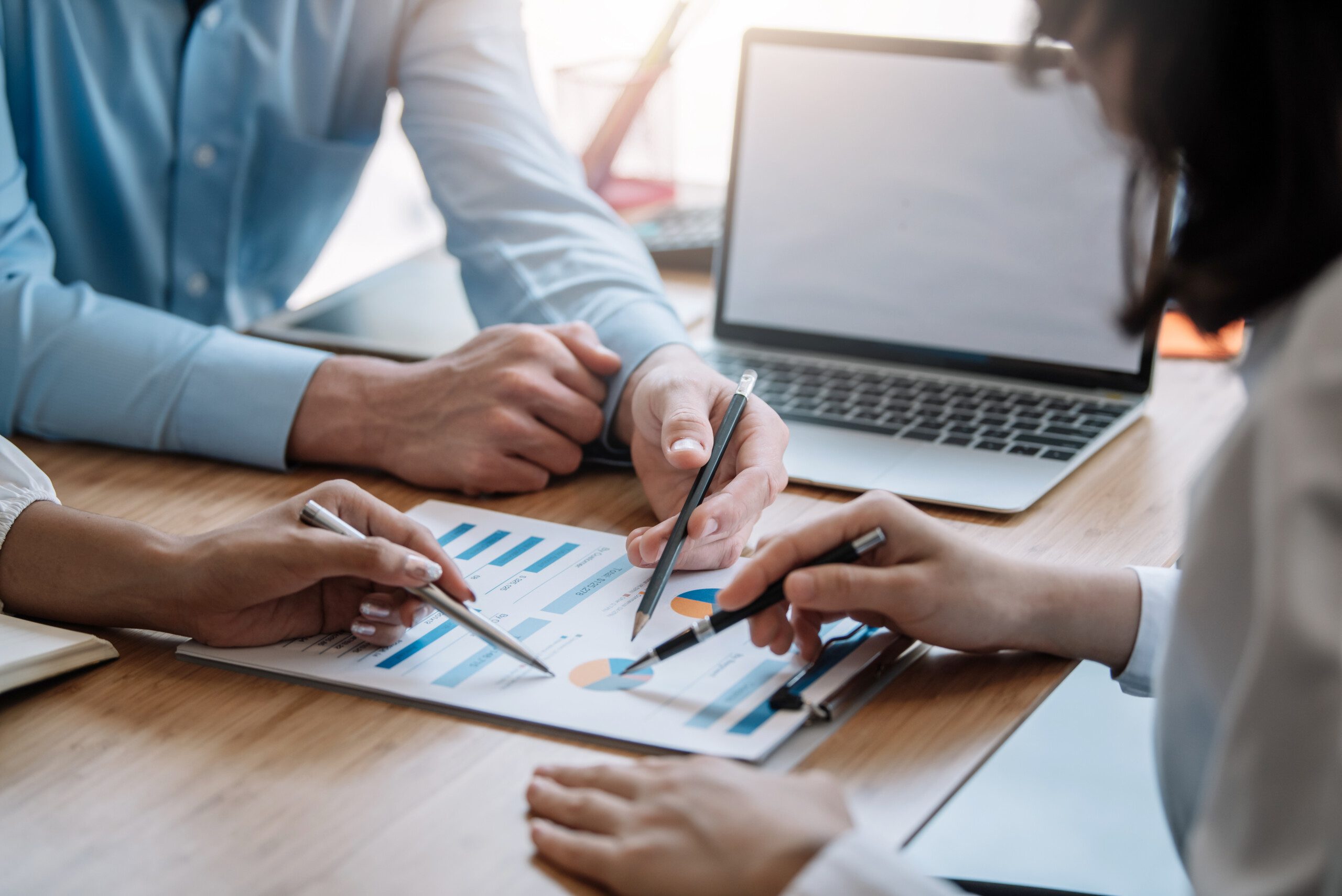 Business people meeting explaining the financial graph data and